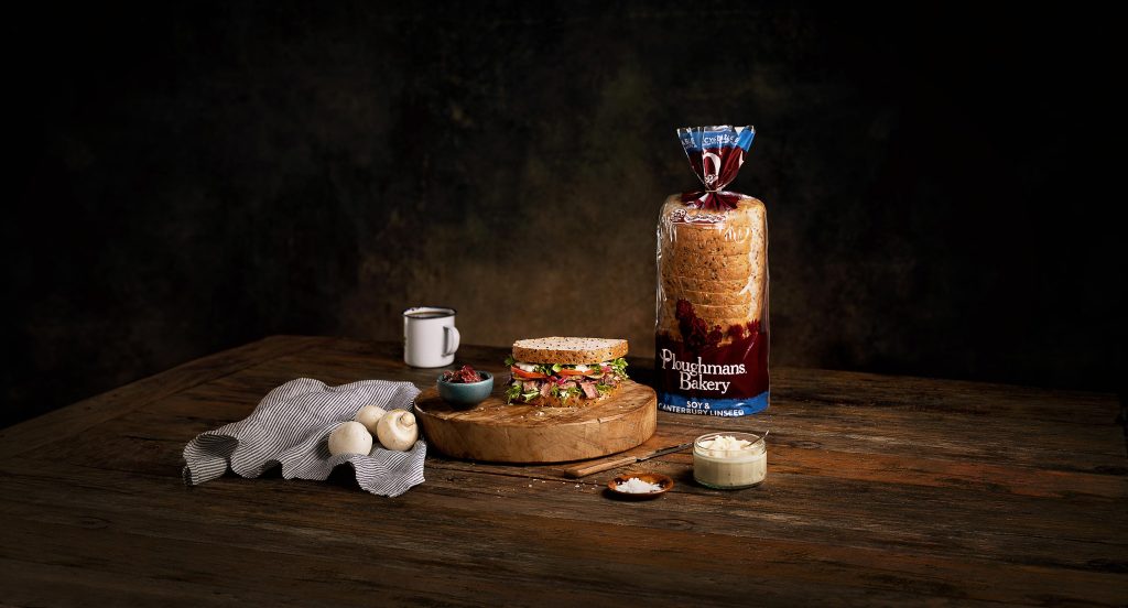 Rustic sandwich on a wooden board with horseradish sauce for Ploughmans Bakery